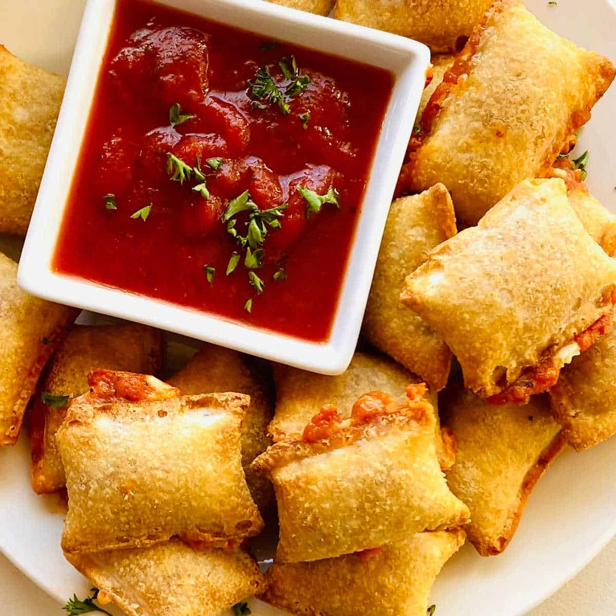 totinos air fryer frozen pizza rolls cooked on plate with marinara