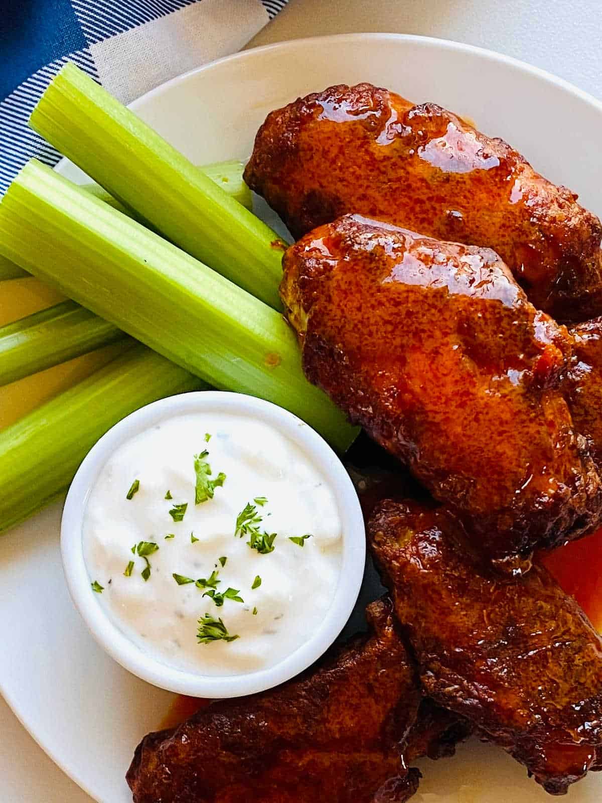 reheated wings in air fryer next to ranch and celery