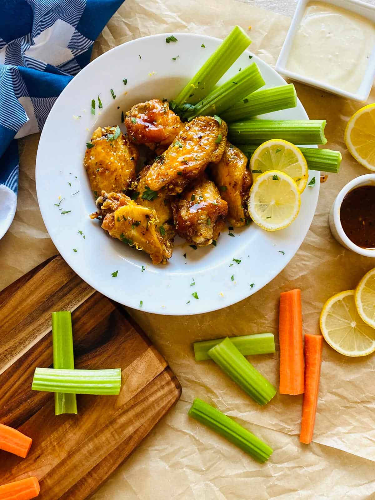 honey lemon pepper wings on plate with celery