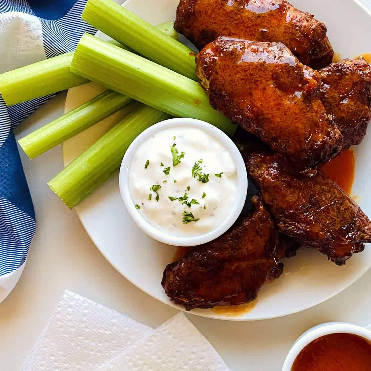 spicy buffalo wings on plate with dipping sauce